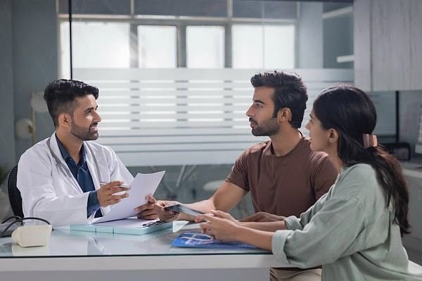 Doctor consulting a patient at home